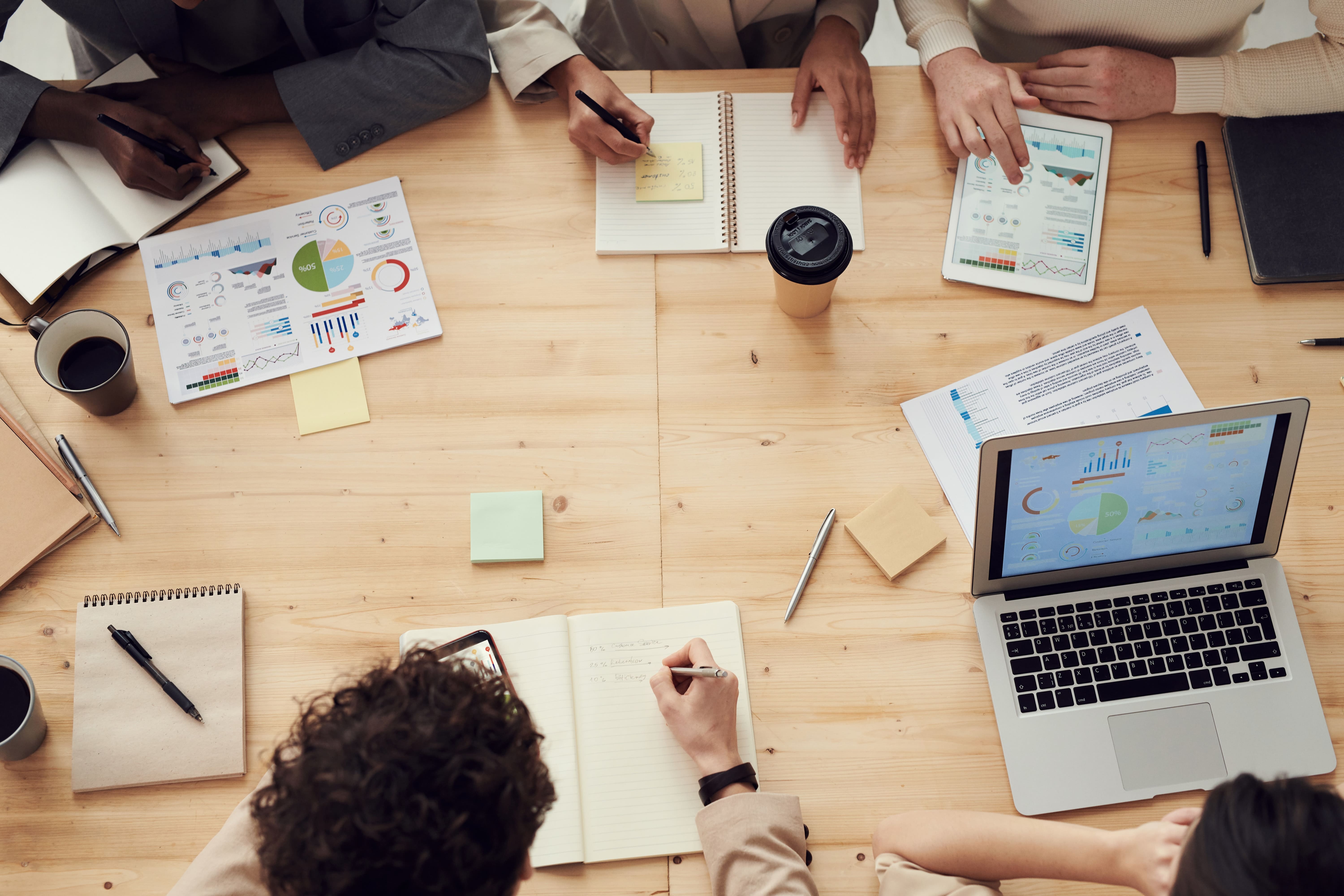 Meeting table with papers on it with financial reports